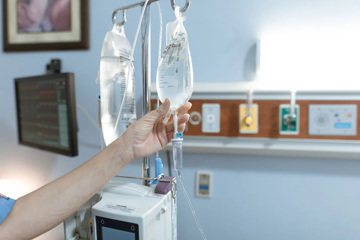 IV drip bags being set up in a clinic room
